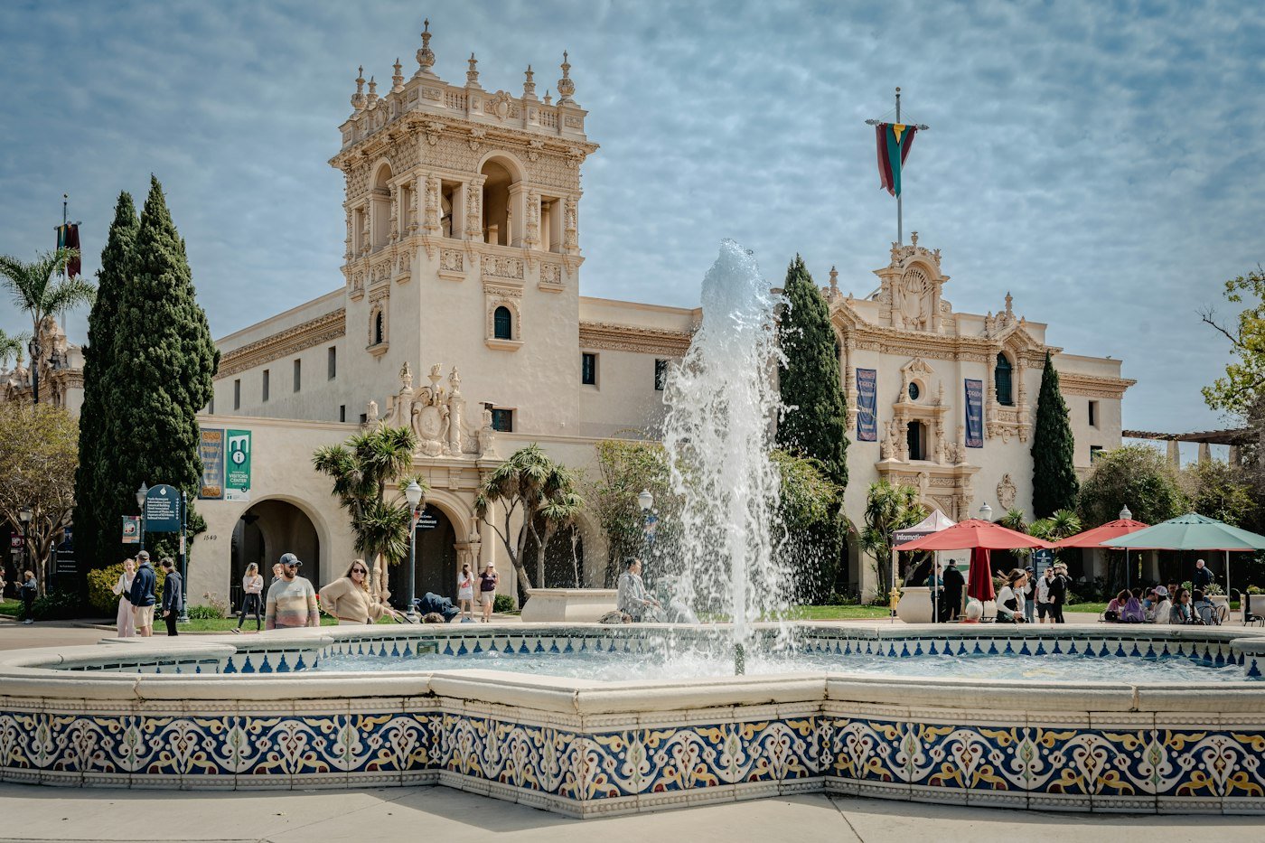 A fountain in front of an ornate building in a plaza