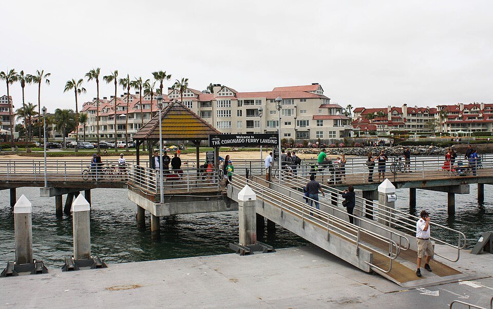 The ferry pier and gangway at the Coronado Ferry Landing, with waterfront buildings behind