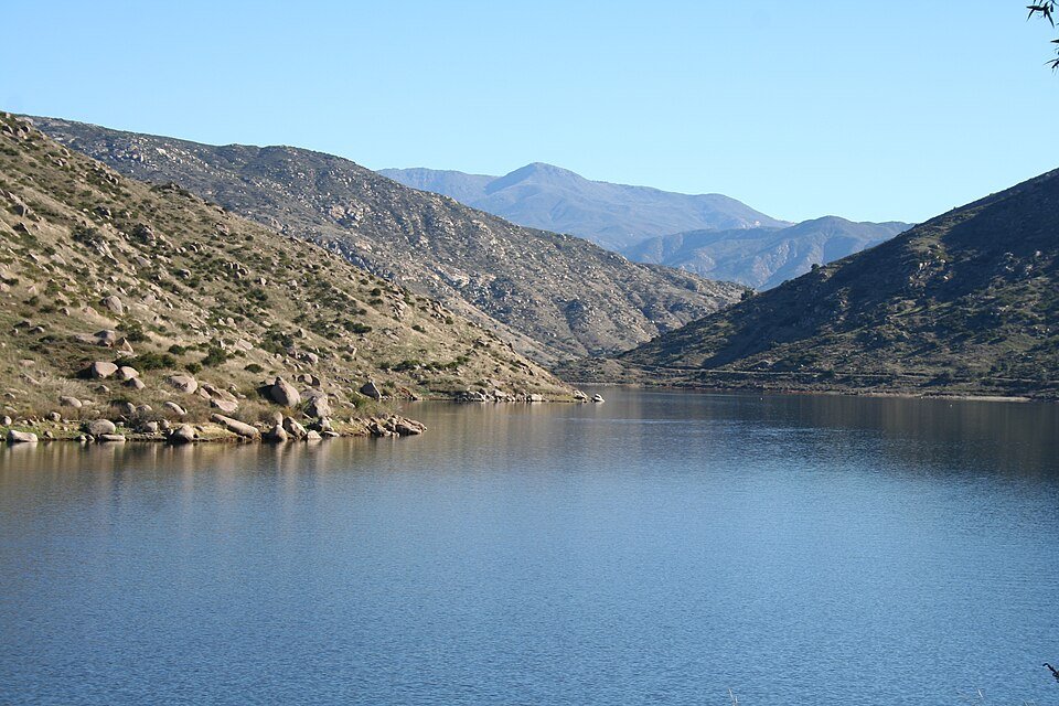 Calm blue water with rocky brown hills at El Capitan Reservoir