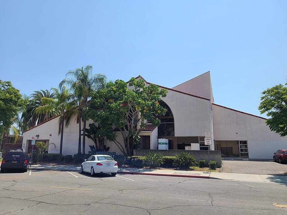 The curved white front and palm trees of the Escondido Public Library