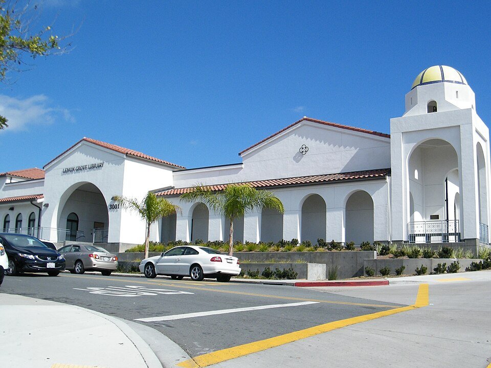 The white Spanish-style Lemon Grove Library with arches and a domed tower