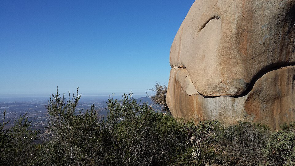 A large boulder beside the Mount Woodson trail with a wide view over the valley