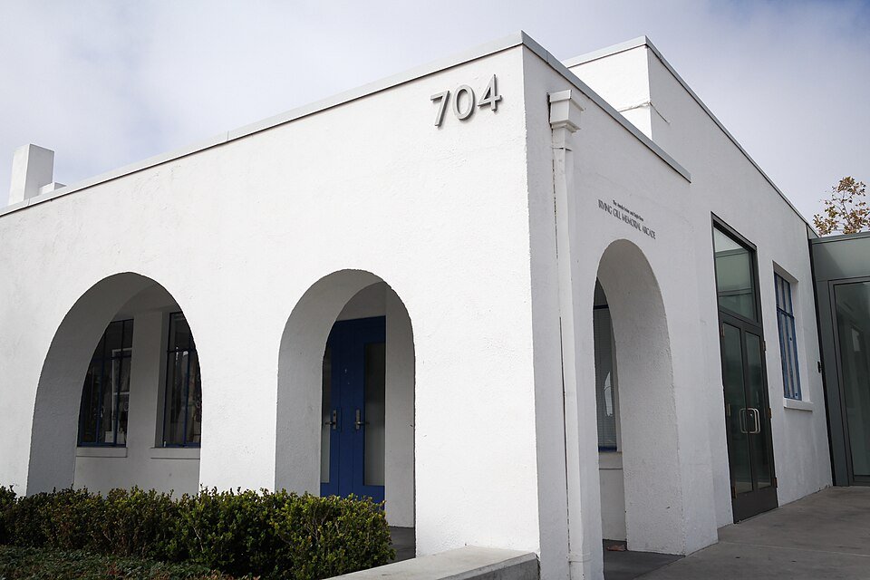 A white building with arched doorways at 704 Pier View Way in Oceanside