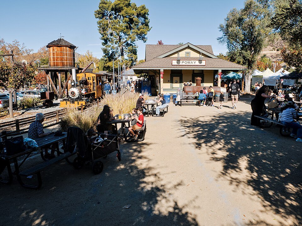 The Poway train depot and water tower at Old Poway Park with visitors at picnic tables