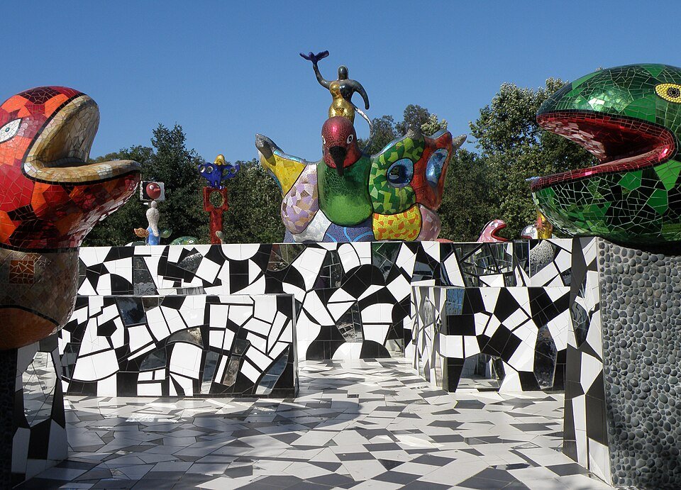 Mosaic bird and animal sculptures and a black and white tiled wall at Queen Califia's Magical Circle