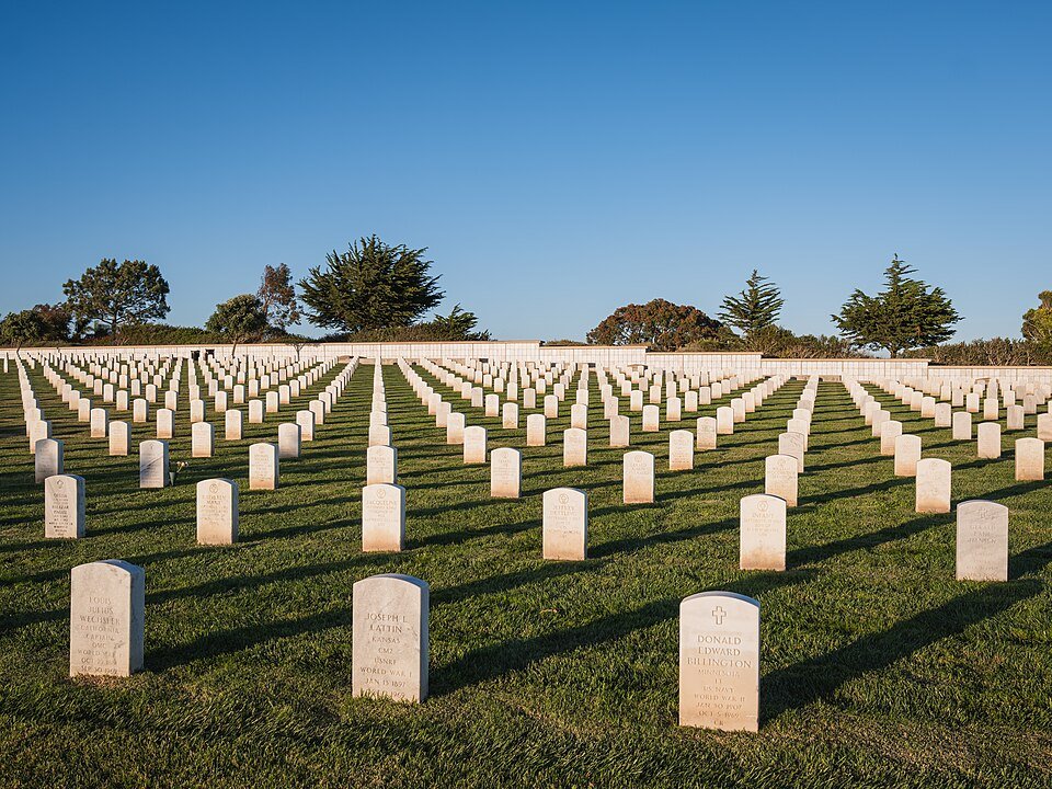 Rows of white headstones in the late sun at Fort Rosecrans National Cemetery