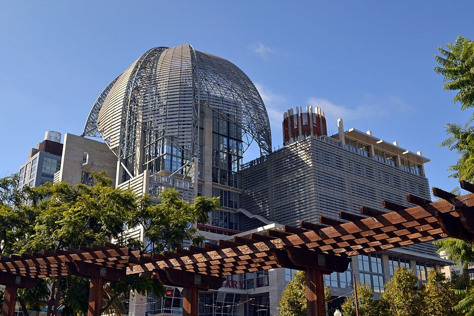 The domed top of the San Diego Central Library seen past a wooden pergola