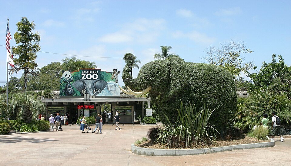 The San Diego Zoo entrance with a large elephant topiary and a painted entrance sign