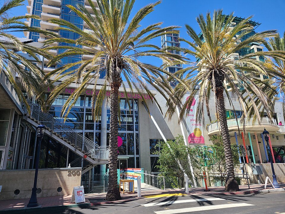 The entrance of The New Children's Museum framed by palm trees in downtown San Diego